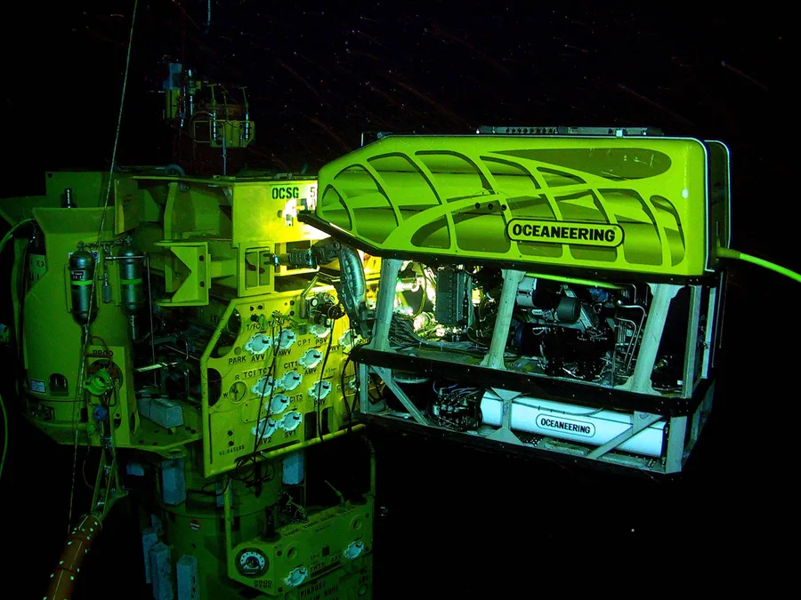 A remotely operated vehicle performing inspection and maintenance work on a subsea structure